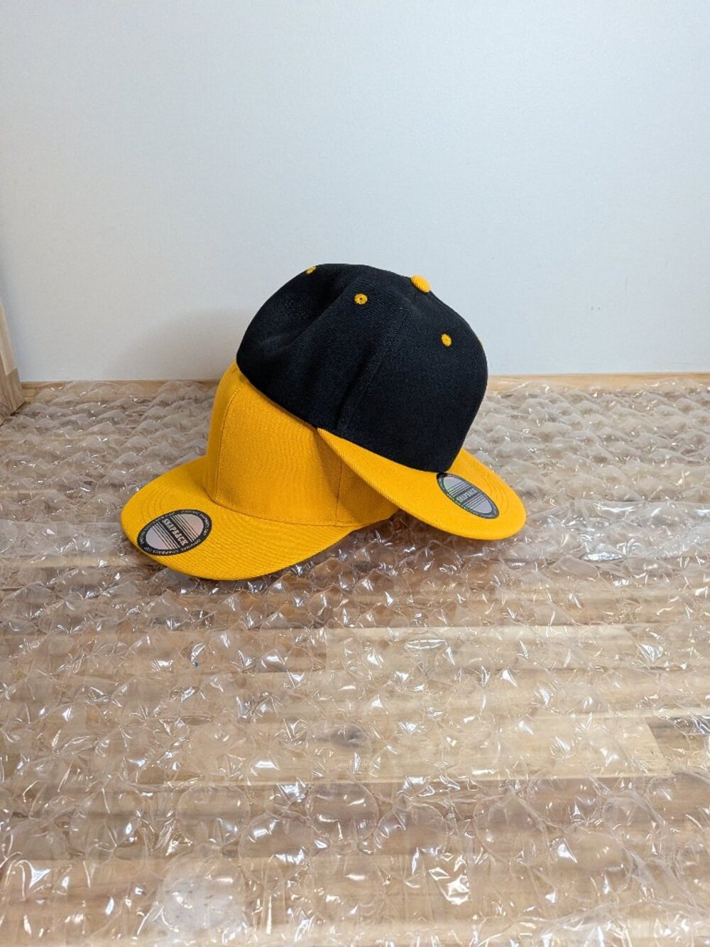 Yellow and black baseball caps.